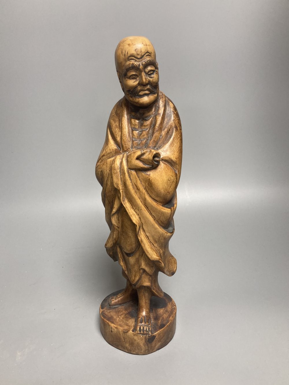 Two Oriental figural wood carvings, tallest 31cm